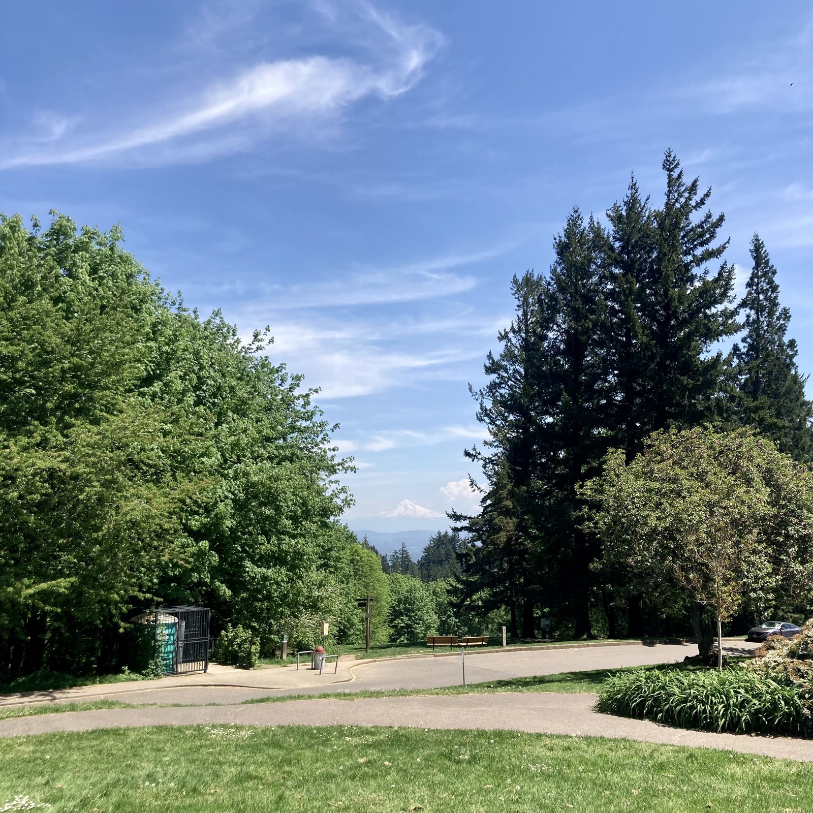 Mt. Hood, seen from Council Crest Park, under a clear sky but hazy at low elevations due to smoke blowing south from a large apartment fire earlier today in Goose Hollow. A single thunderhead is over the southern shoulder of the mountain, perhaps hundreds of miles distant