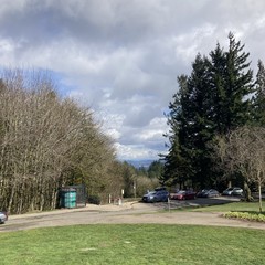 View from Council Crest Park toward Mt. Hood, which is obscured by many fluffy wet clouds moving swiftly eastward on an otherwise sunny spring day