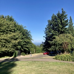 Mt. Hood as seen from Council Crest Park on a late summer afternoon. The sky is completely clear, but two small wisps of haze are near the peak of the mountain